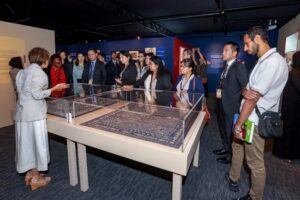 Tan Huism, Executive Director of QNL, giving a tour of QNL’s Qatar-Indonesia Year of Culture 2023 exhibition to CDNLAO delegates